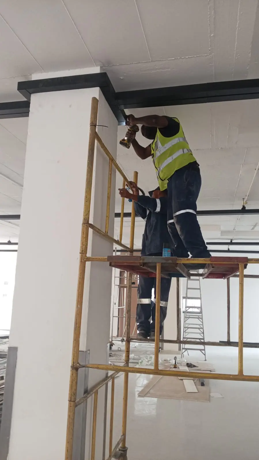 Electrician performing lighting maintenance